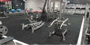 Indoor gym facility at Game On Turf with varied fitness equipment and strength training machines for multi-sport readiness