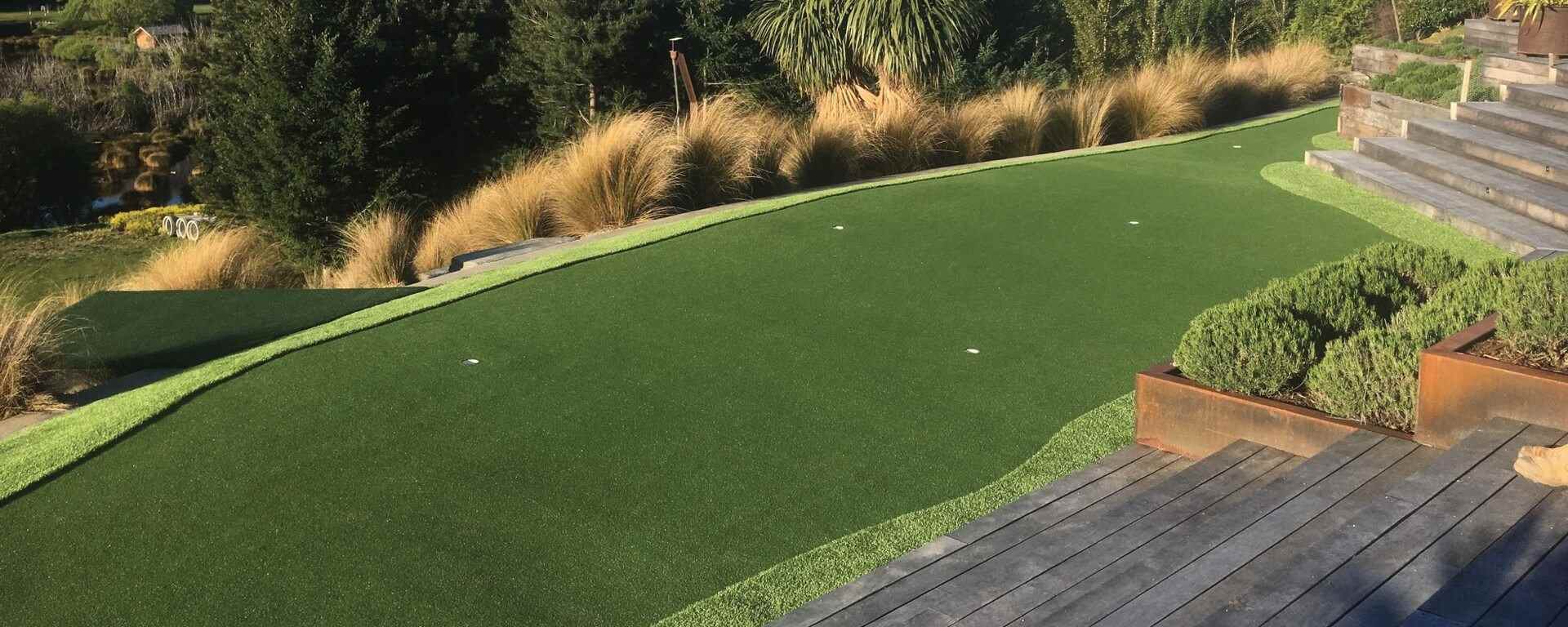 Artificial Sports Turf features lush green synthetic grass with clean edging and surrounding plants, reflecting Advanced Polymer Technology (APT) and SYNLawn innovations in eco-friendly, durable turf